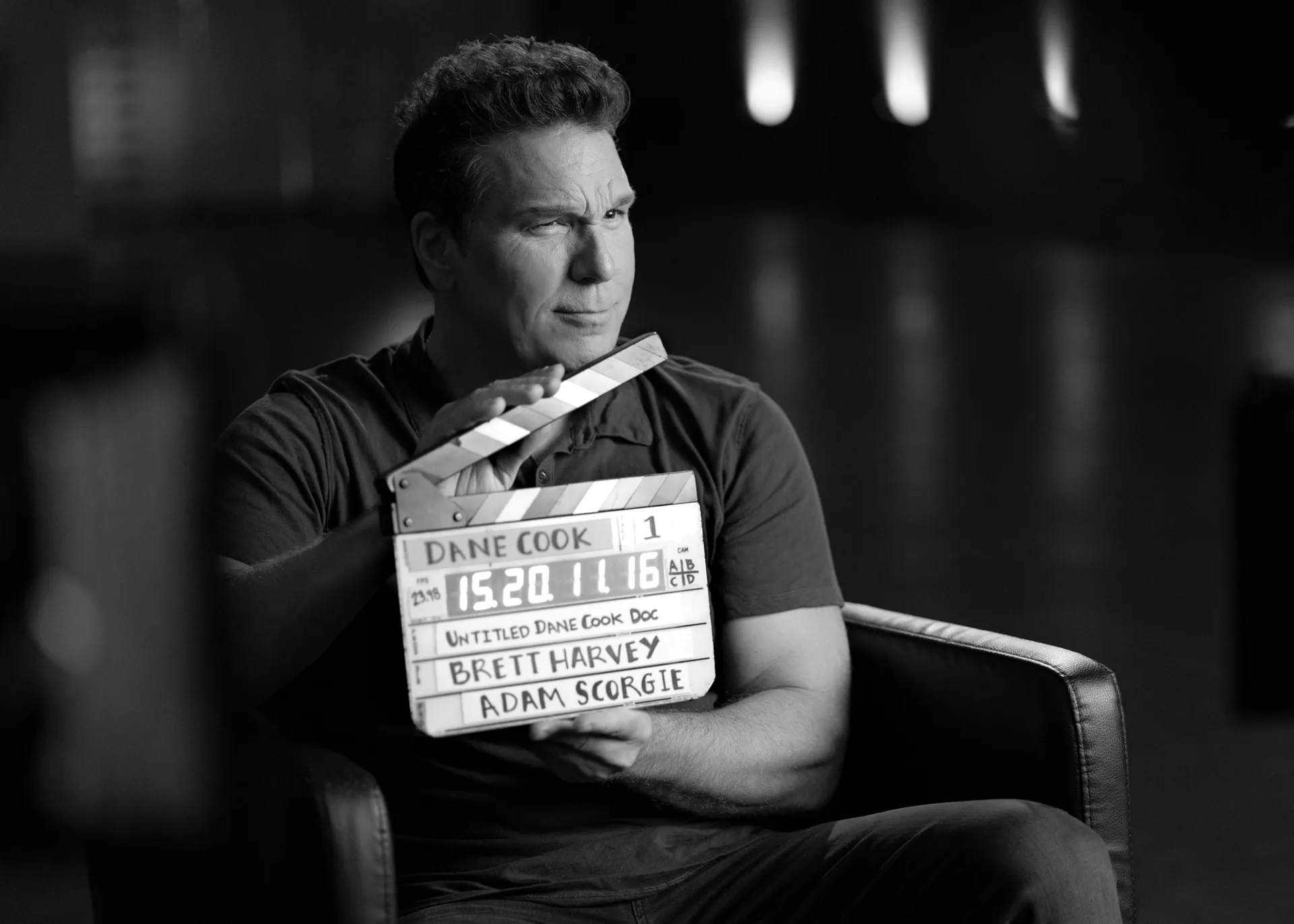 Dane Cook holding a Score G production slate during an interview for Funny Money