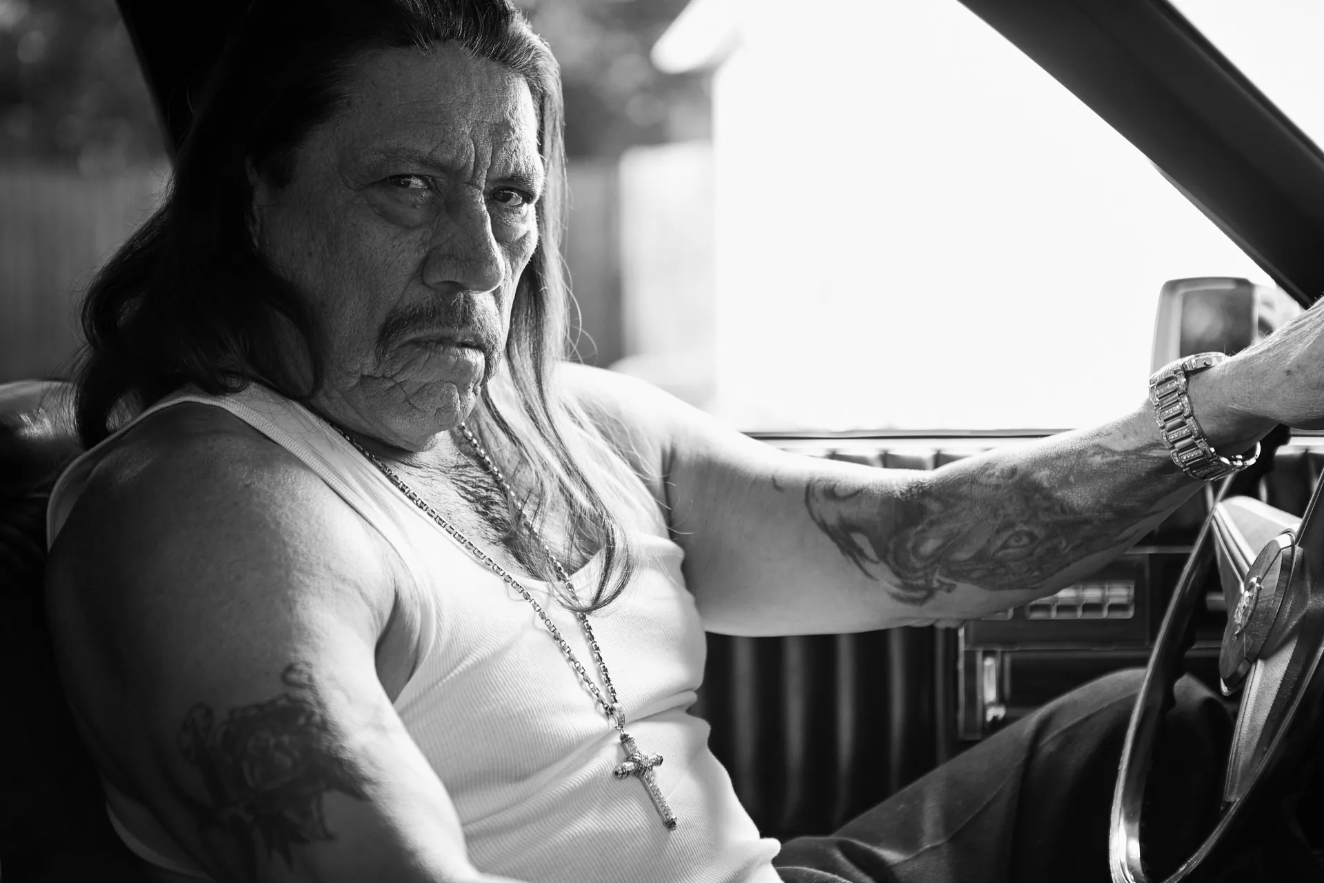 Danny Trejo behind the wheel of a car during filming of Inmate #1